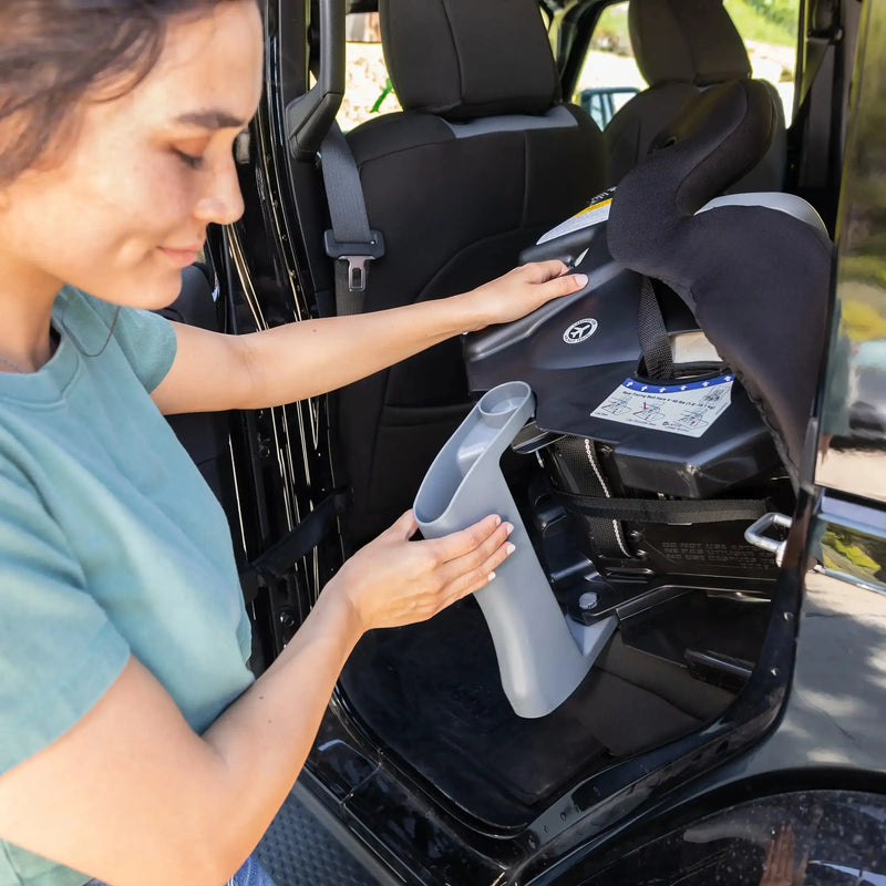 A mom is using the recline flip foot on the Baby Trend Trooper PLUS 3-in-1 Convertible Car Seat with Canopy