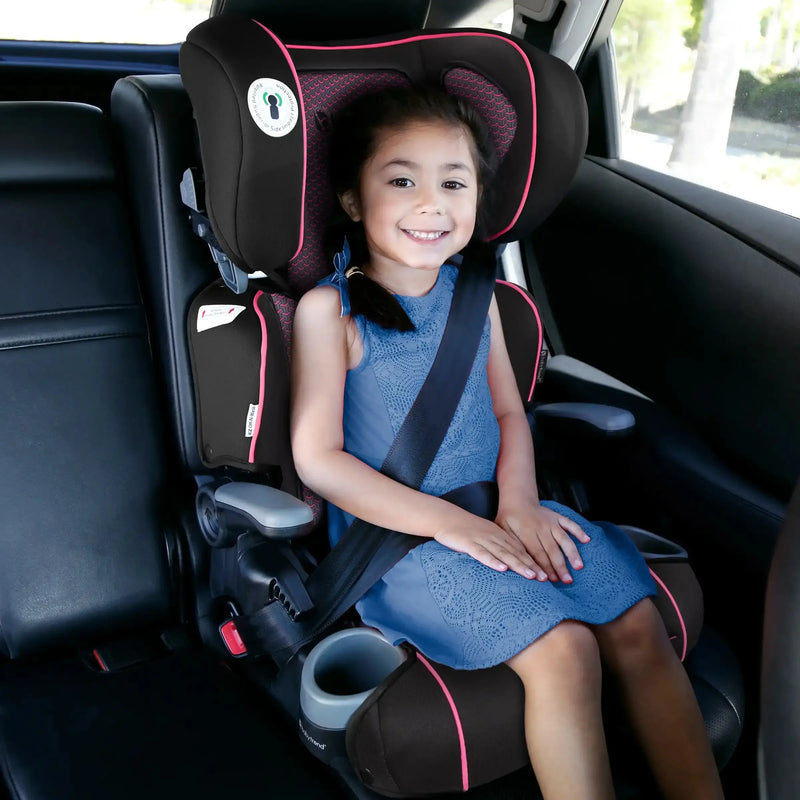 A girl is sitting in the Baby Trend PROtect 2-in-1 Folding Booster Car Seat