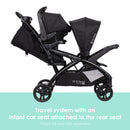 Load image into gallery viewer, Baby Trend Sit N' Stand Double 2.0 Stroller travel system with an infant car seat attached to the rear seat