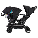 Load image into gallery viewer, Baby Trend Sit N Stand Double Stroller side view with infant car seat in front and child seat in back