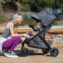 Load image into gallery viewer, A mom is looking after her child sitting in the Baby Trend Tango 3 All-Terrain Stroller