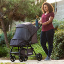 Load image into gallery viewer, A mother and her child strolling outdoor with the Baby Trend Passport Carriage Stroller