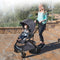 A mom is pushing her baby in the Baby Trend Sonar Switch 6-in-1 Modular Stroller