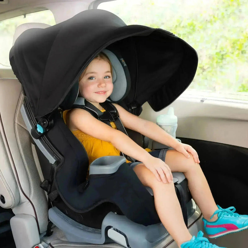 A child is sitting in the Baby Trend Cover Me Convertible Car Seat with front facing mode